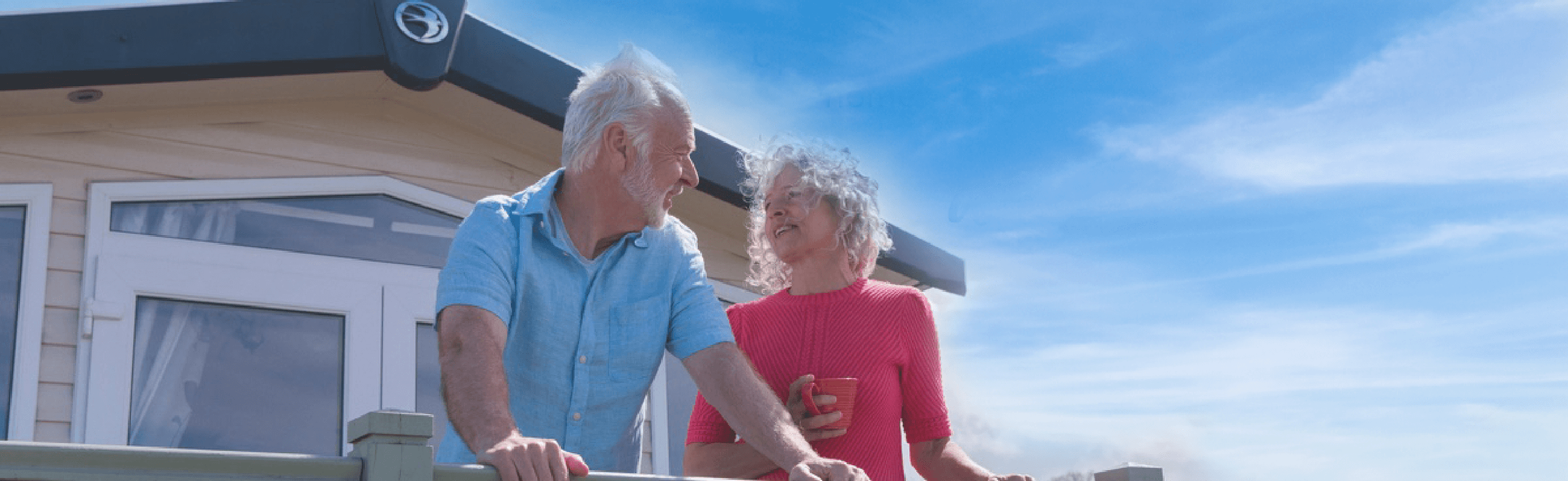 Photograph of a couple outside a caravan